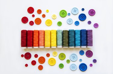 Spools of thread and buttons in the colors of the rainbow