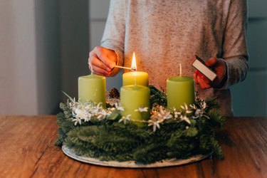 Lighting the first candle on swiss advent wreath.