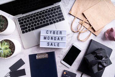 cyber monday sale text on lightbox, top view of workspace flat lay