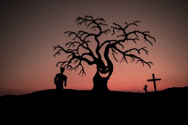 Silhouette some zombies on the cemetery walking around at sunset. Selective focus