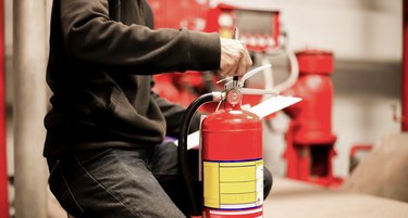 The red fire extinguisher is ready for use in case of an indoor fire emergency.