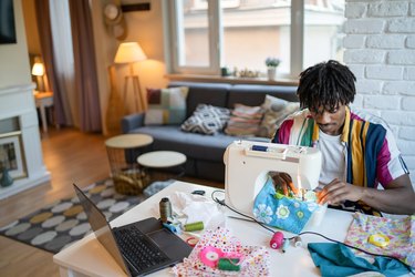 Man busy sewing material on a machine