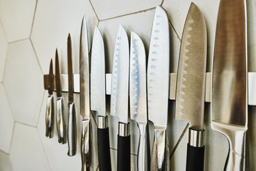 Kitchen knives on magnetized strip on wall