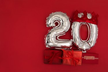 Foil balloons with number 20 on red background