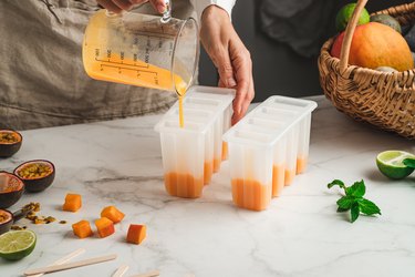 Woman preparing mix fruit ice cream popsicles