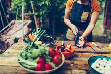 Young woman cutting vegetables outdoor