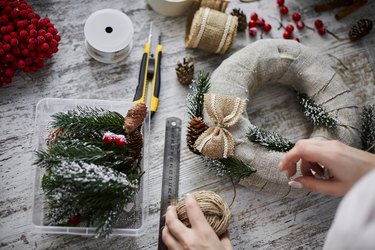 Close-up of craftswoman making Advent wreath