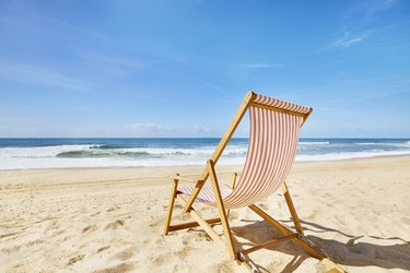 Striped deck chair on beach