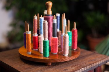 Close-Up Of Multi Colored Spools On Table