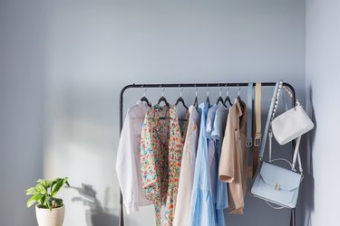 Premium Photo  Colorful womens clothes on wood hangers on rack on blue