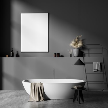 Grey bathroom interior with tub, decoration and ladder, mockup poster