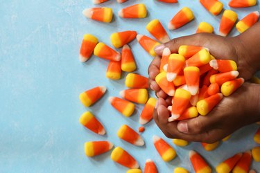Child's hands holding Halloween candy corn
