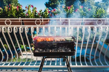 Food Being Cooked On Barbecue Grill On Balcony