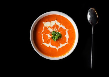 Tomato cream soup on black background