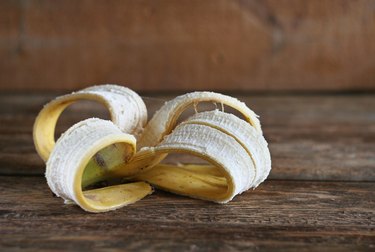 A banana peel lies on a wooden brown table: zero waste