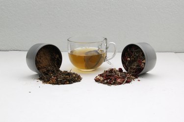 Glass mug and tea infuser with canisters of loose leaf tea