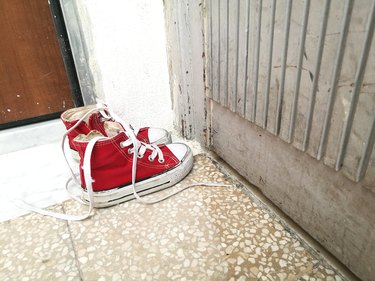 High Angle View Of Kids Converse Red Shoes On Floor