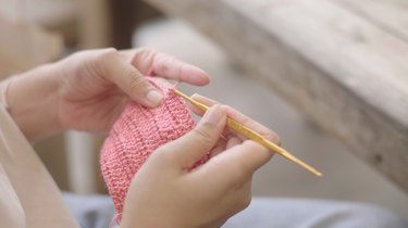 View of knitting with pink yarn.