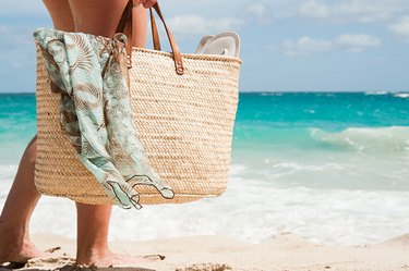 Woman carrying beach bag, Mustique, Grenadine Islands