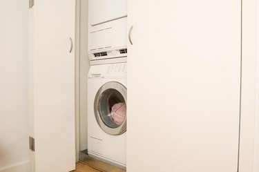 Washer and dryer stacked in closet