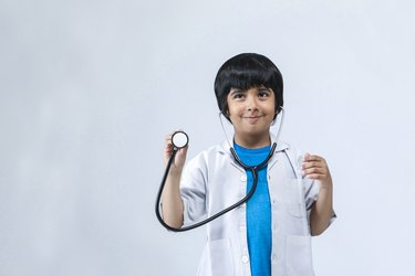 Nurture their interests- Child dressed as doctor
