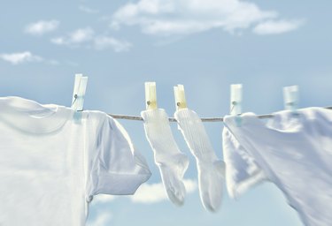 Clothes on clothesline against sky background