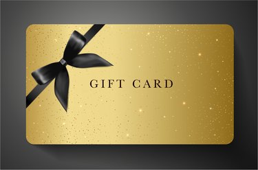 Gift card with twinkling stars, sparkling elements and back bow (ribbon) on gold background