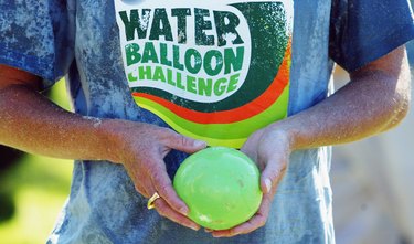 Woman holding water balloon