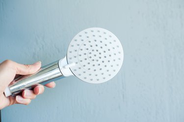 Hand holds a showerhead