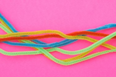 Closeup of Pipe cleaners, chenille stems on pink background