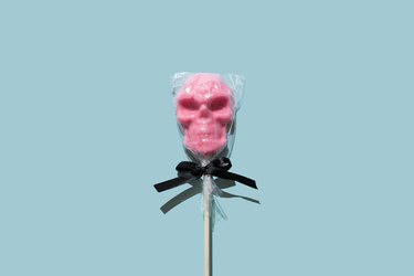 Pink lollipop in the shape of a skull