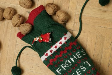 A Christmas stocking with walnuts an a Santa Claus pin