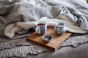 High Angle View Of Tea With Milk Served On Bed At Home