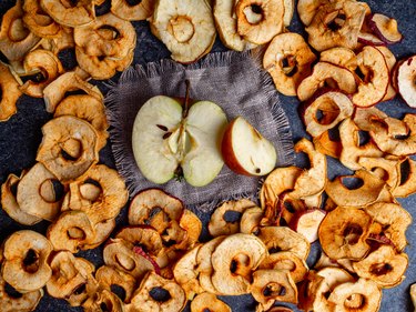 fresh applewith pieces of dry in dehydrator slices of yellow and red apples, healthy snack