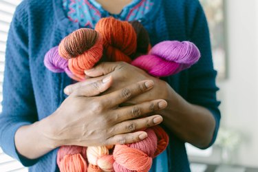Cropped View of Woman Clutching Colorful Yarn