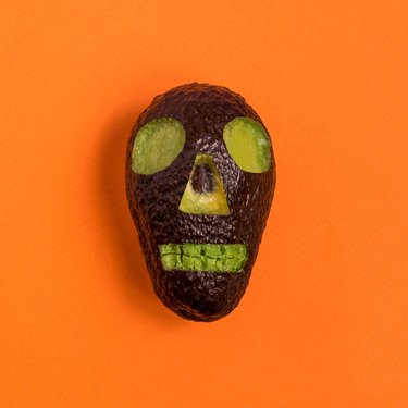 Skull carved out of avocado for Halloween party