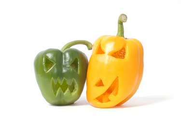 Faces carved into peppers for Halloween