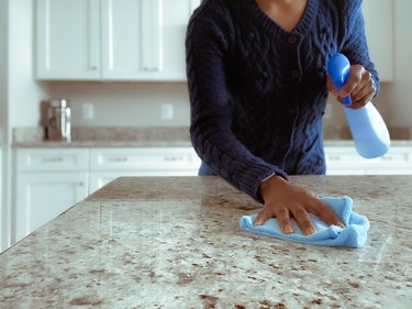 Woman Cleans Kitchen Counter
