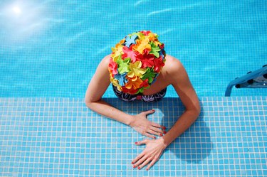 Woman at swimming pool ledge