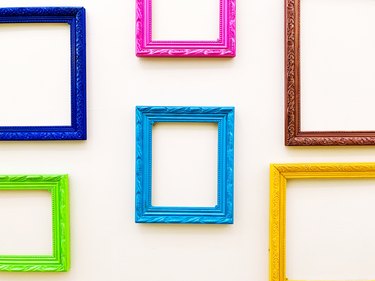 Multicolored Empty Picture Frames Hanging On Wall