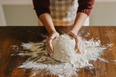 Woman kneading bread dough