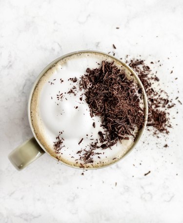 Cup of hot chocolate on white background