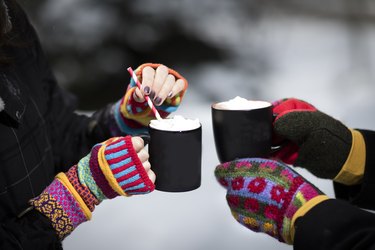 Winter Scene of Hot cocoa and girls hands in mittens