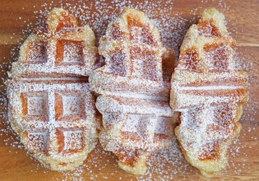 Mouthwatering freshly baked croffles sprinkled with powdered sugar