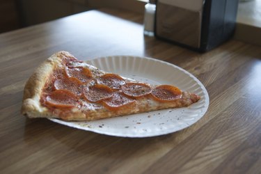 Greasy Pizza Slice on Table