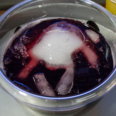 Ice hand floating in punch bowl