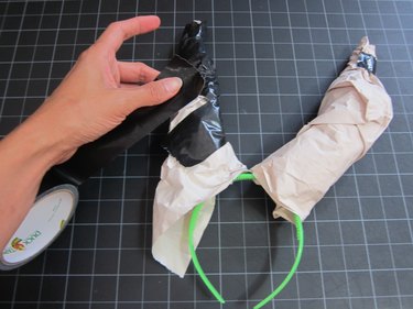Wrapping the newspaper horn with tape