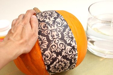 Place the wet paper on the pumpkin