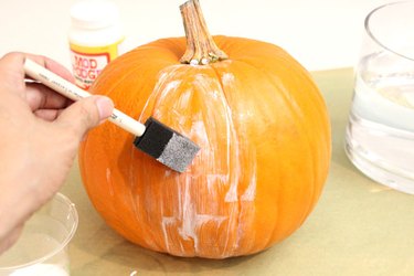 Apply decoupage medium to the pumpkin