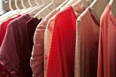 Dressing closet with complementary colors blue and orange clothes.